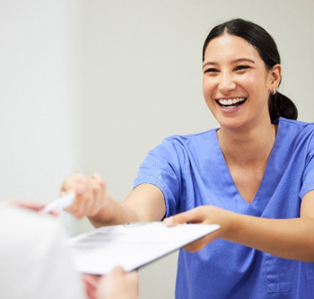 A woman filling out dental insurance forms