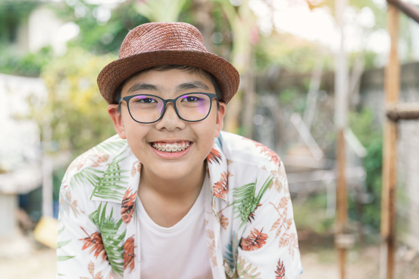 Teen boy with braces smiling