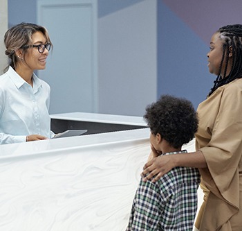 Mother and son talking to a receptionist
