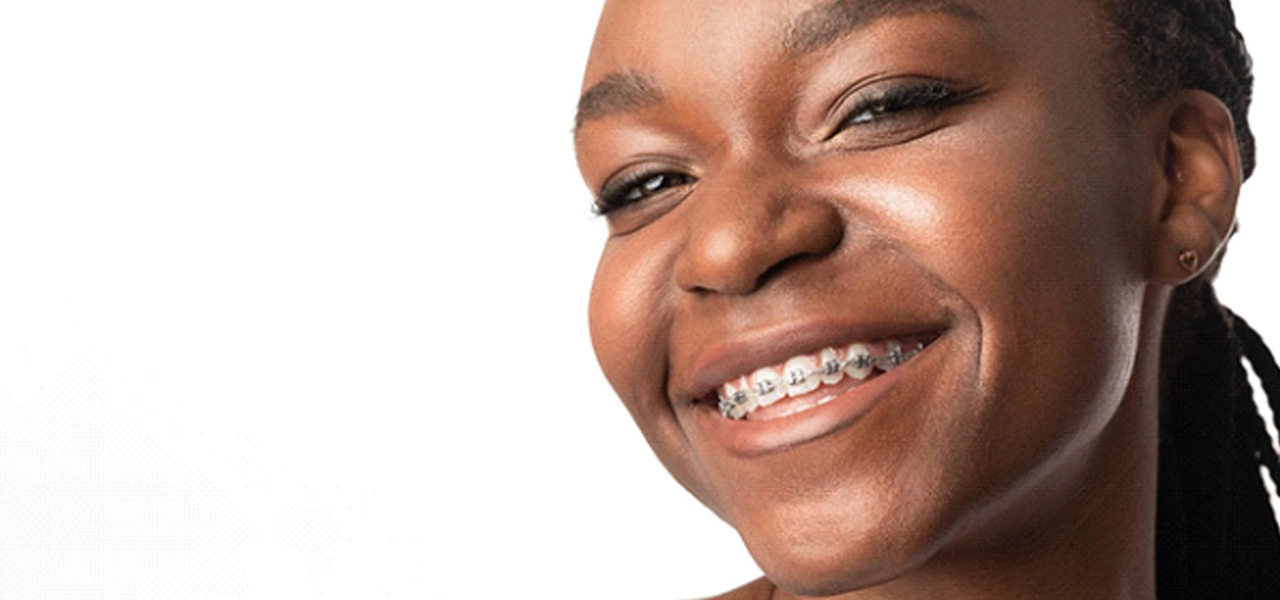 Smiling girl with metal braces in Frisco and Prosper on white background