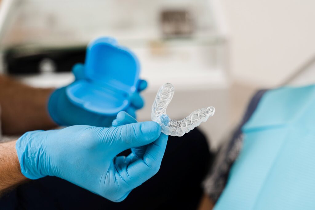 Orthodontist handing patient clear aligner
