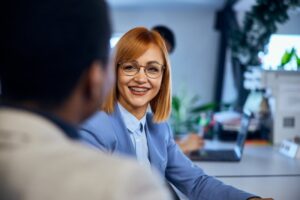 Woman with braces smiling at work